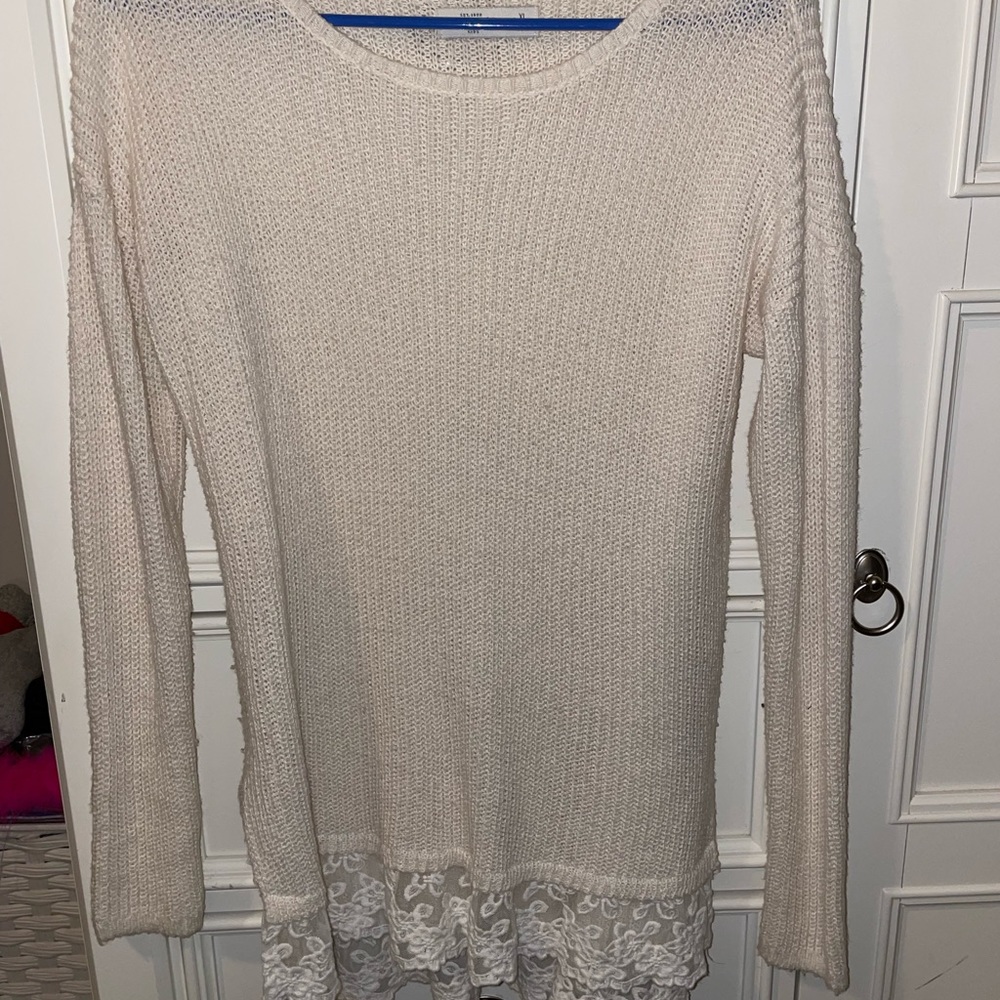 Cream sweater with floral detailing on the bottom